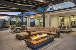 View of patio / terrace featuring an outdoor living space with a fire pit and outdoor dining area