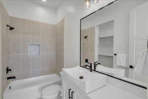Full bath featuring vanity and washtub / shower combination