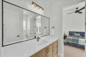 Ensuite bathroom featuring vanity, a ceiling fan, and recessed lighting