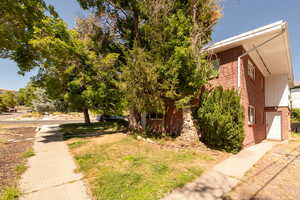 View of property exterior with brick siding