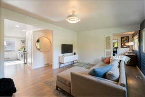 Living room with light wood finished floors and baseboards