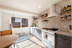 Kitchen with white appliances, extractor fan, light countertops, open shelves, and recessed lighting