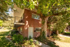 View of home's exterior featuring a balcony and brick siding