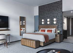 Carpeted bedroom featuring a barn door