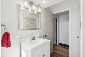 Bathroom featuring vanity and wood finished floors
