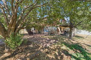 View of yard featuring stairs, mature trees