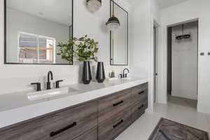 Bathroom with double vanity and tile patterned flooring