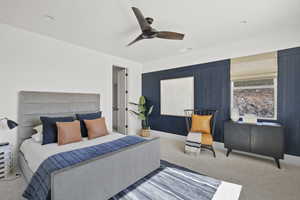 Carpeted bedroom featuring a ceiling fan
