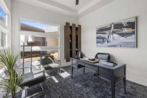 Carpeted home office with baseboards