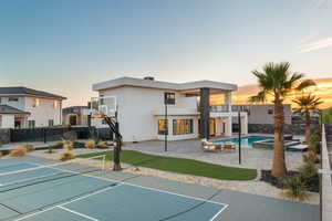 View of sport court featuring a pool with connected hot tub