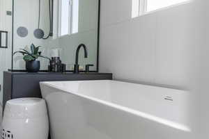 Bathroom featuring a freestanding bath and a sink