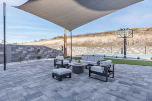 Fenced backyard featuring an outdoor living space, a patio area, and a swimming pool