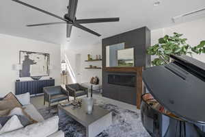 Living room featuring a ceiling fan, recessed lighting, and a fireplace