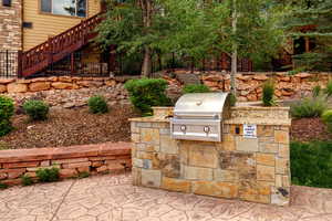 View of patio / terrace featuring exterior kitchen and stairway
