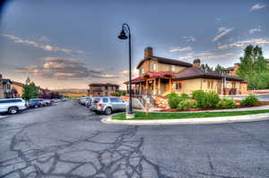 View of front of home featuring a chimney and uncovered parking