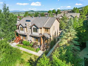 View of front of home featuring a chimney, a shingled roof, and a mountain view