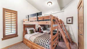 Bedroom featuring baseboards and carpet