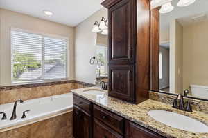 Bathroom with double vanity and a bath