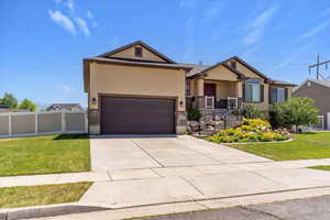 Craftsman-style house featuring stucco siding, brick siding, concrete driveway, and an attached garage