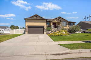 Ranch-style house with stucco siding, driveway, and an attached garage
