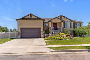 Craftsman inspired home with brick siding, stucco siding, concrete driveway, and a garage