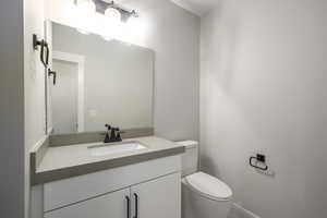 Half bath featuring vanity and toilet