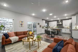 Living room with recessed lighting, plenty of natural light, and wood finished floors