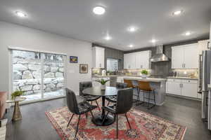 Dining area with dark wood-style flooring and recessed lighting