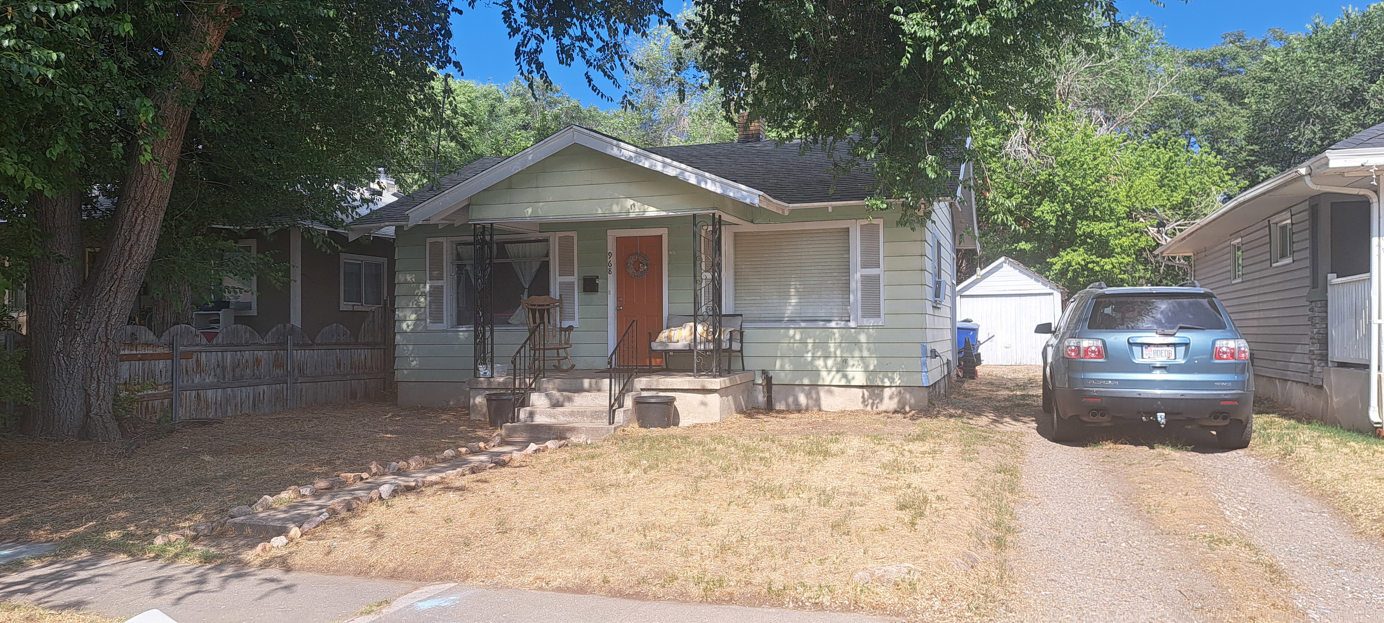 Bungalow-style home with covered porch and an outdoor structure