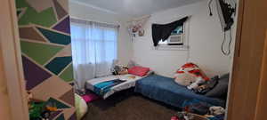 Bedroom featuring carpet flooring and cooling unit