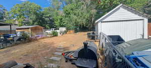 View of yard with a shed and view of scattered trees