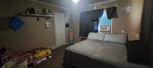 Bedroom with dark carpet and cooling unit