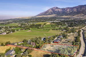 Aerial view of property and surrounding area featuring property parcel outlined and mountains