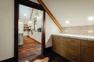 Bathroom featuring tasteful backsplash, dark wood-type flooring, and recessed lighting