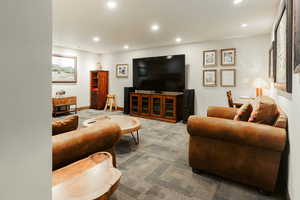 Carpeted living area featuring recessed lighting