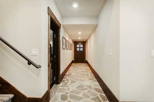Hallway featuring baseboards and recessed lighting