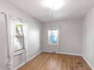 Unfurnished room featuring light wood-style floors and baseboards