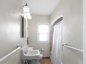 Bathroom featuring shower / bath combo and toilet