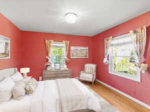 Bedroom featuring light wood-type flooring and baseboards