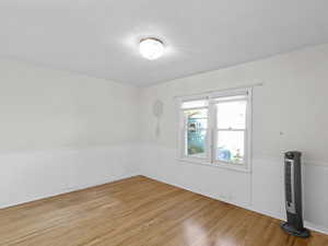 Empty room with wainscoting and light wood finished floors