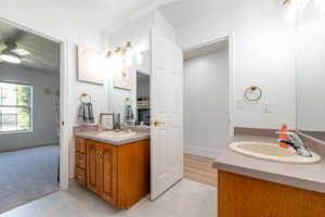 Full bath with vanity and baseboards