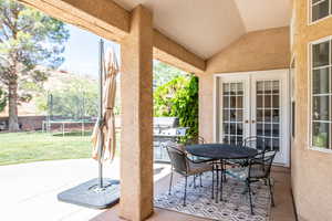 View of patio / terrace with french doors, a trampoline, outdoor dining space, and area for grilling