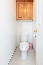 Bathroom featuring baseboards and toilet