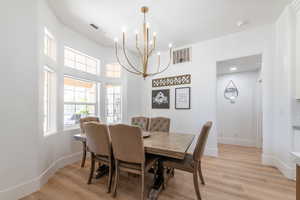 Dining space with a chandelier and light wood-style floors