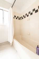 Full bathroom with shower / bath combo with shower curtain
