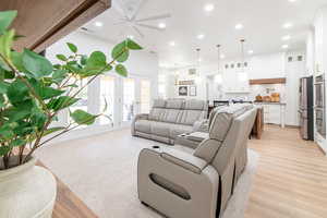 Living area featuring recessed lighting, ceiling fan, light wood-style floors, a chandelier, and french doors