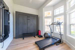 Workout area with light wood finished floors