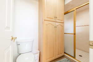 Full bath with a shower stall and tile patterned flooring