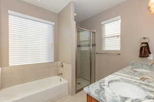 Bathroom with a shower stall, a garden tub, and double vanity