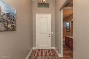 Foyer featuring wood finished floors and baseboards